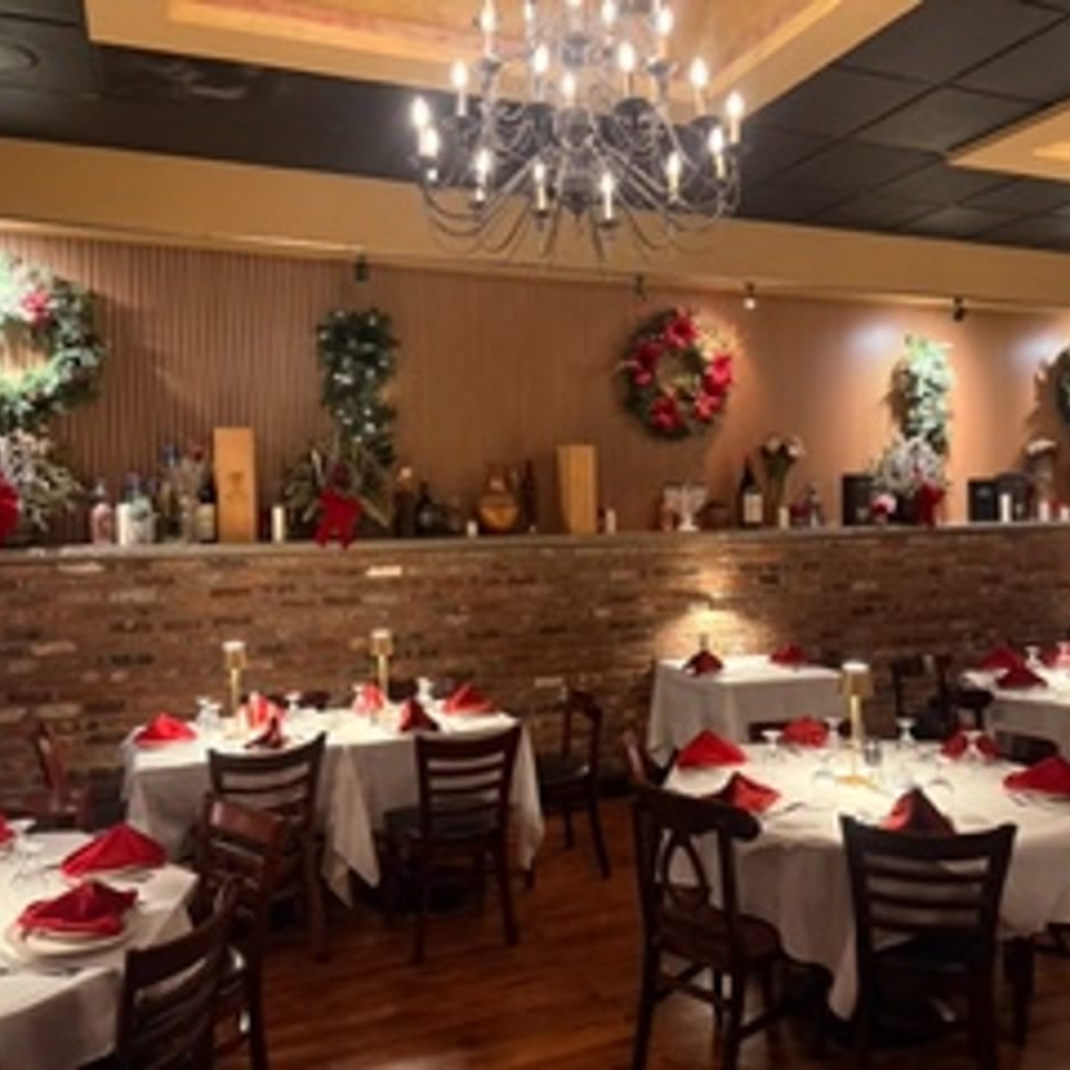 Dining room set with holiday wreaths and red table settings