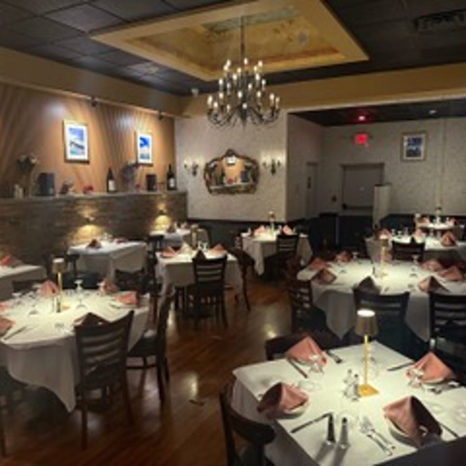 Elegant dining room with chandelier and set tables